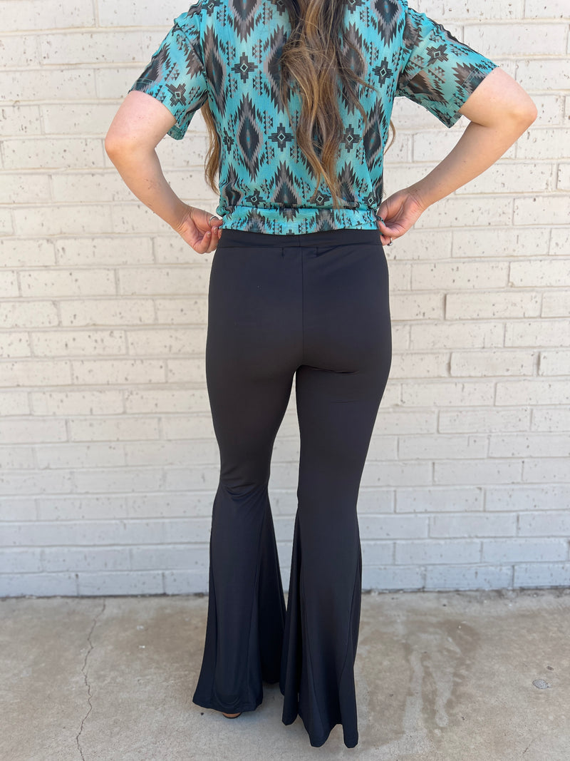 Sterling Kreek Bell Bottoms. Bell Bottoms. black pants. High waisted pants. black Bell bottoms. Stretchy pants. Comfortable pants. Western style. Women's western wear. Women's black pants. Women's western boutique. Women's western wear. Online boutique. Small business. Woman owned. 